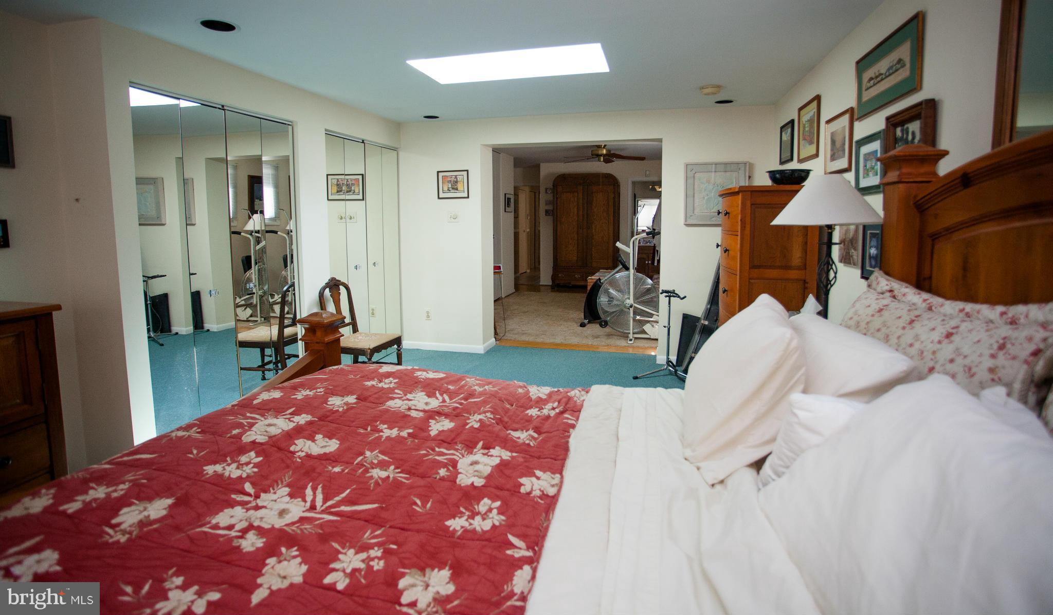 9407 Jodale Road Randallstown, MD 21133 - Photo 13 of 26 a bed room with a bed and a mirror