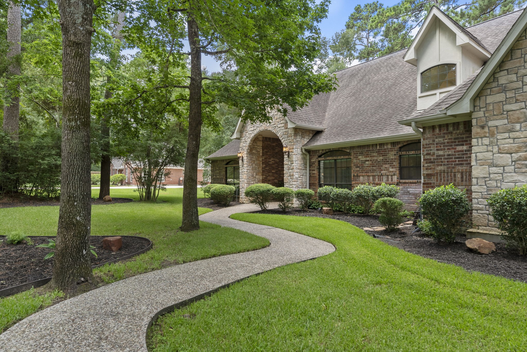 24311 Standing Oak Drive Spring, TX 77389 - Photo 4 of 42 a front view of a house with garden