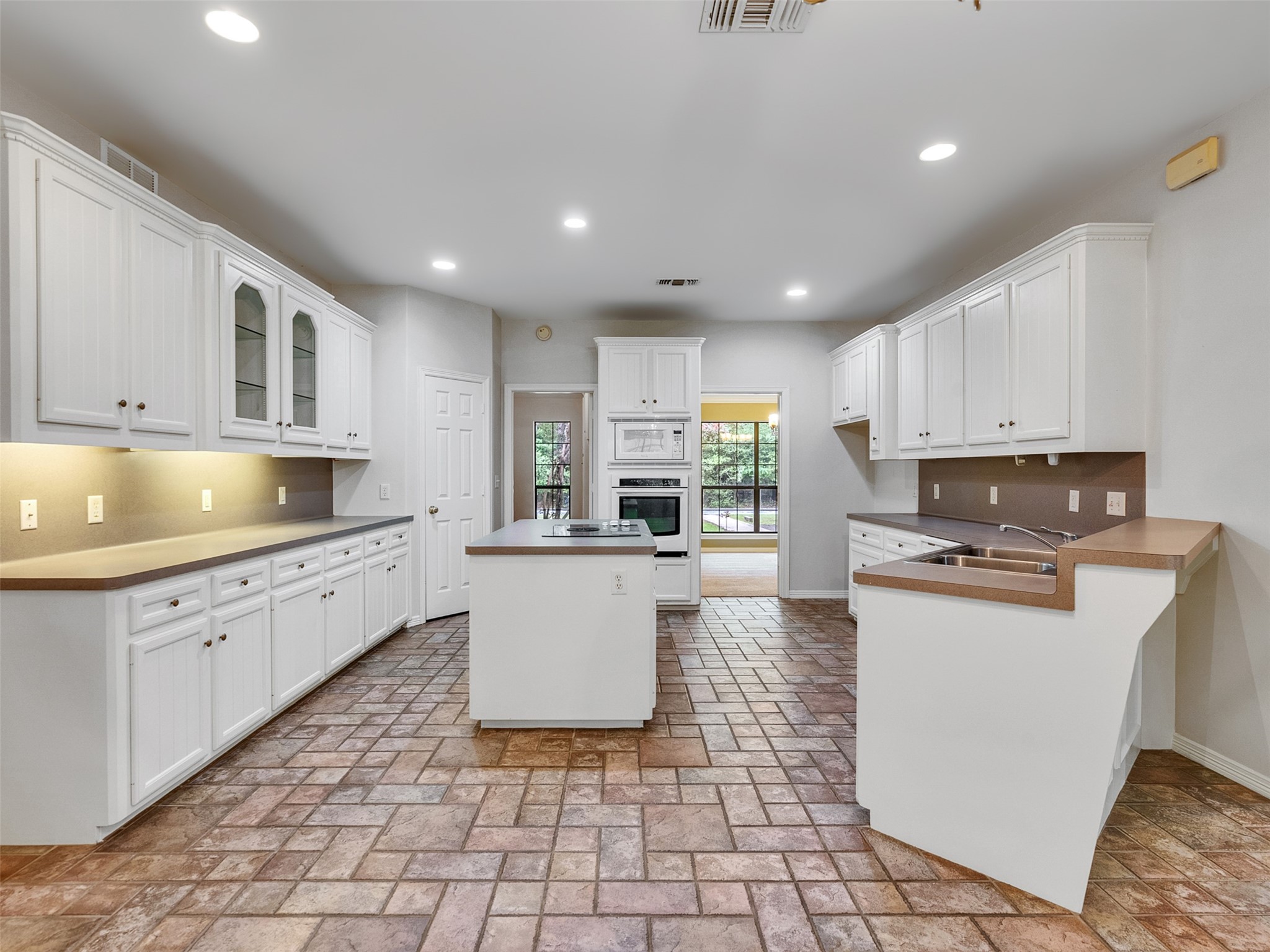 195 Coral Gables Trinity, TX 75862 - Photo 11 of 50 a kitchen with stainless steel appliances granite countertop a stove a sink a microwave and a refrigerator