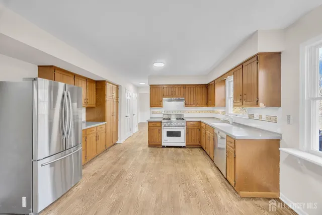 a kitchen with stainless steel appliances a refrigerator and a stove