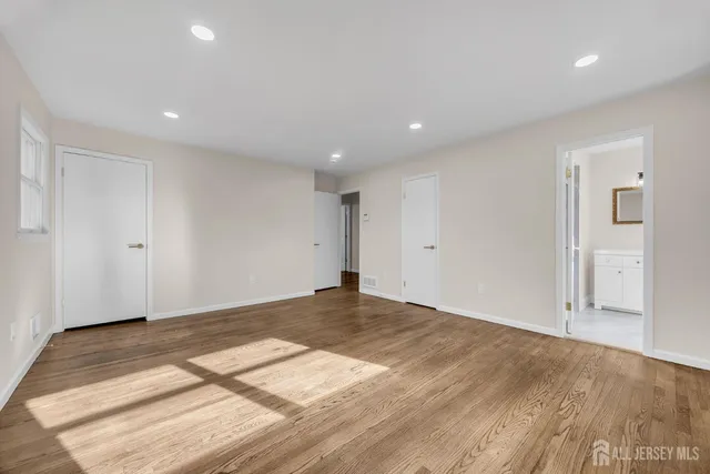 a bathroom with a double vanity sink a mirror and a window
