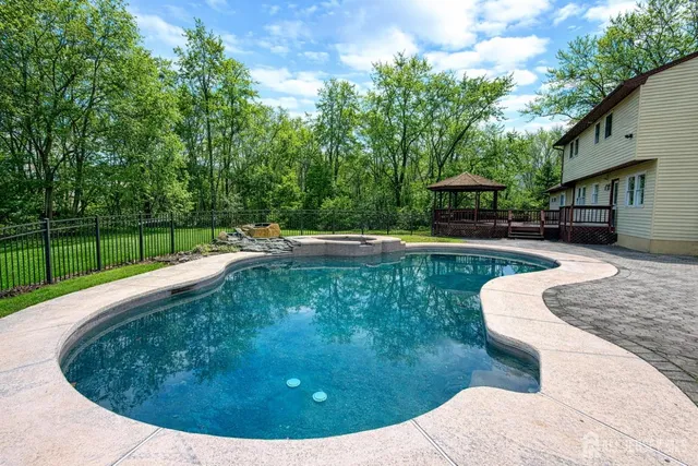 a view of a backyard with a garden and entertaining space