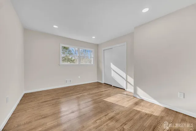a bathroom with a granite countertop double vanity sink and mirror