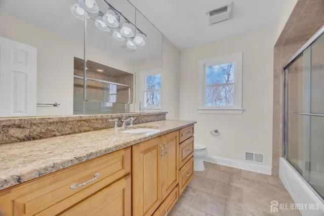 a bathroom with a sink a vanity and mirror