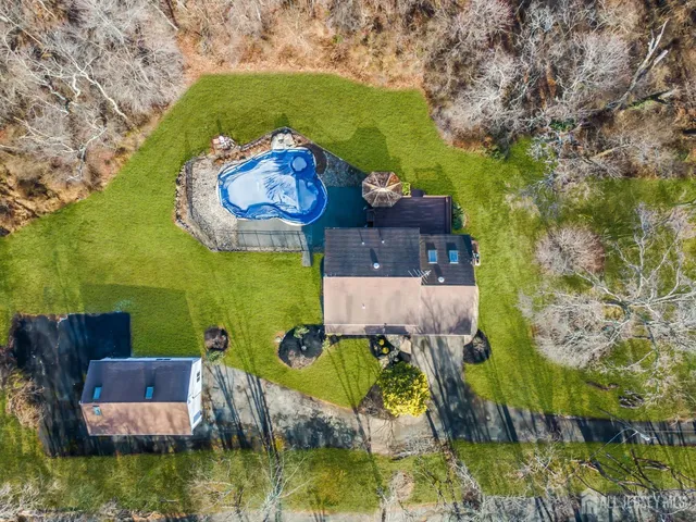 an aerial view of a house with a garden and swimming pool