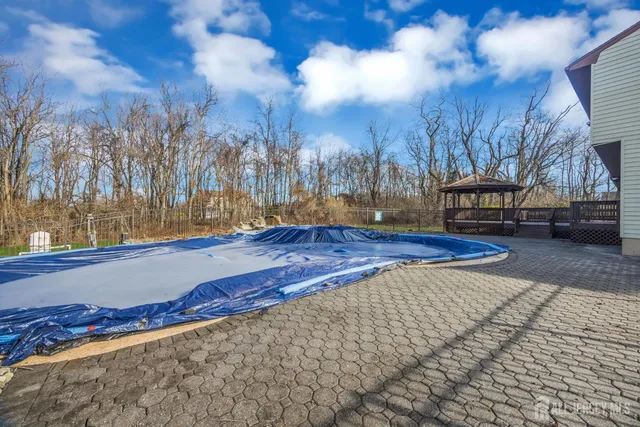a aerial view of a house with yard swimming pool and outdoor seating