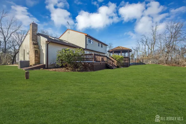 a view of a dry yard with wooden fence