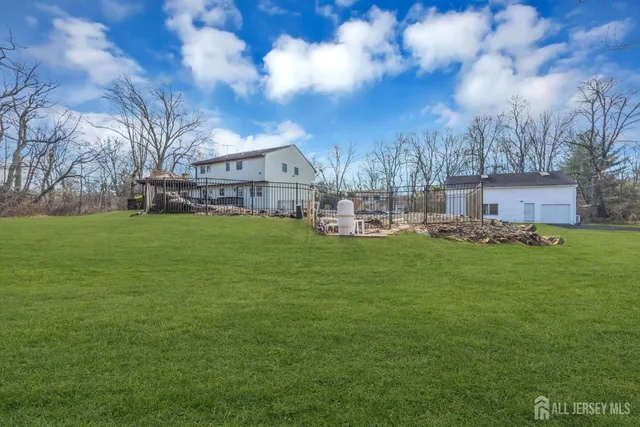 an aerial view of a house with garden space and swimming pool