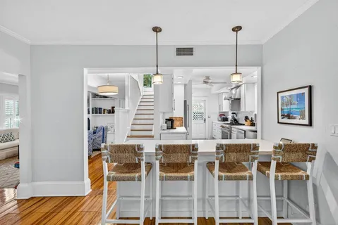 a dining room with furniture and wooden floor