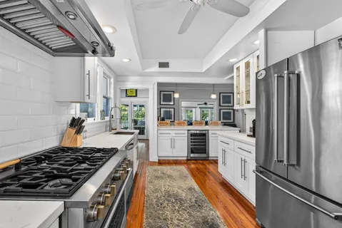 a kitchen with granite countertop a stove and a refrigerator