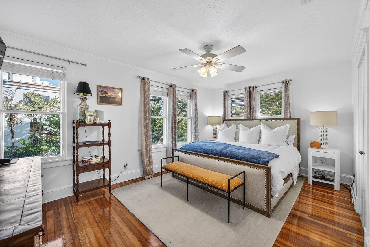 307 Wildermere Road West Palm Beach, FL 33401 - Photo 25 of 54 a spacious bedroom with a bed a dresser and a book shelf