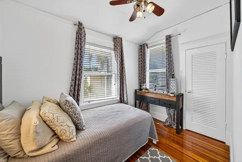 a bedroom with a bed and a chandelier