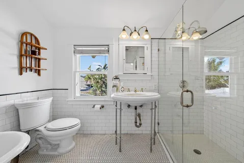 a bathroom with a toilet sink and mirror