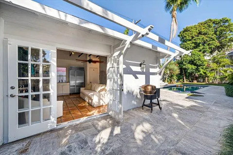a view of a house with backyard porch and sitting area