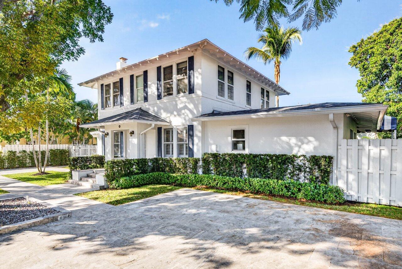 307 Wildermere Road West Palm Beach, FL 33401 - Photo 4 of 54 a front view of a house with a yard and potted plants