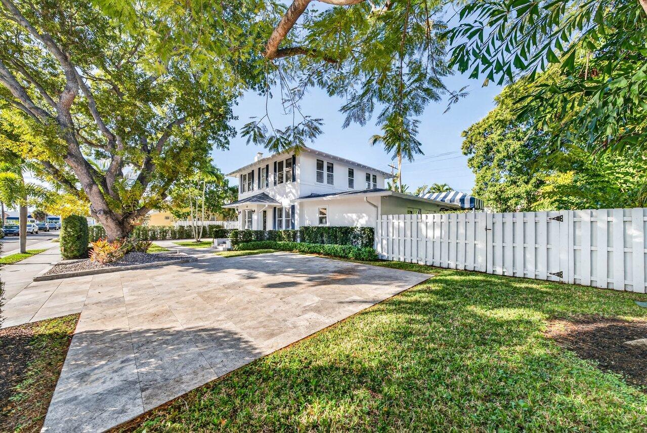 307 Wildermere Road West Palm Beach, FL 33401 - Photo 42 of 54 a view of a brick house next to a yard with large trees