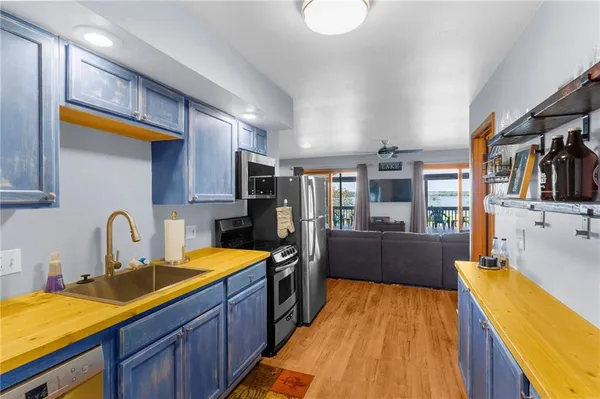 a kitchen with stainless steel appliances granite countertop a stove a sink and a refrigerator