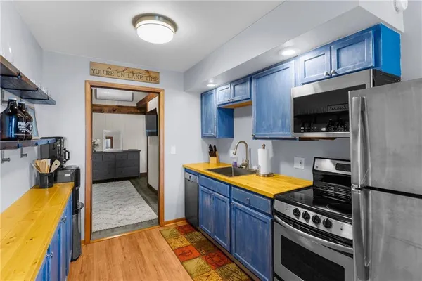 a kitchen with wooden cabinets and a stove