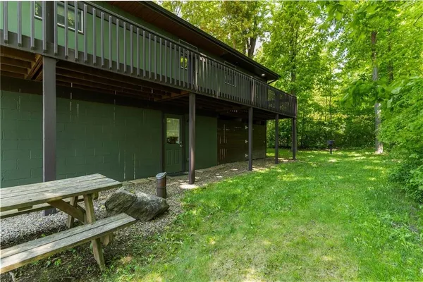a backyard of a house with barbeque oven