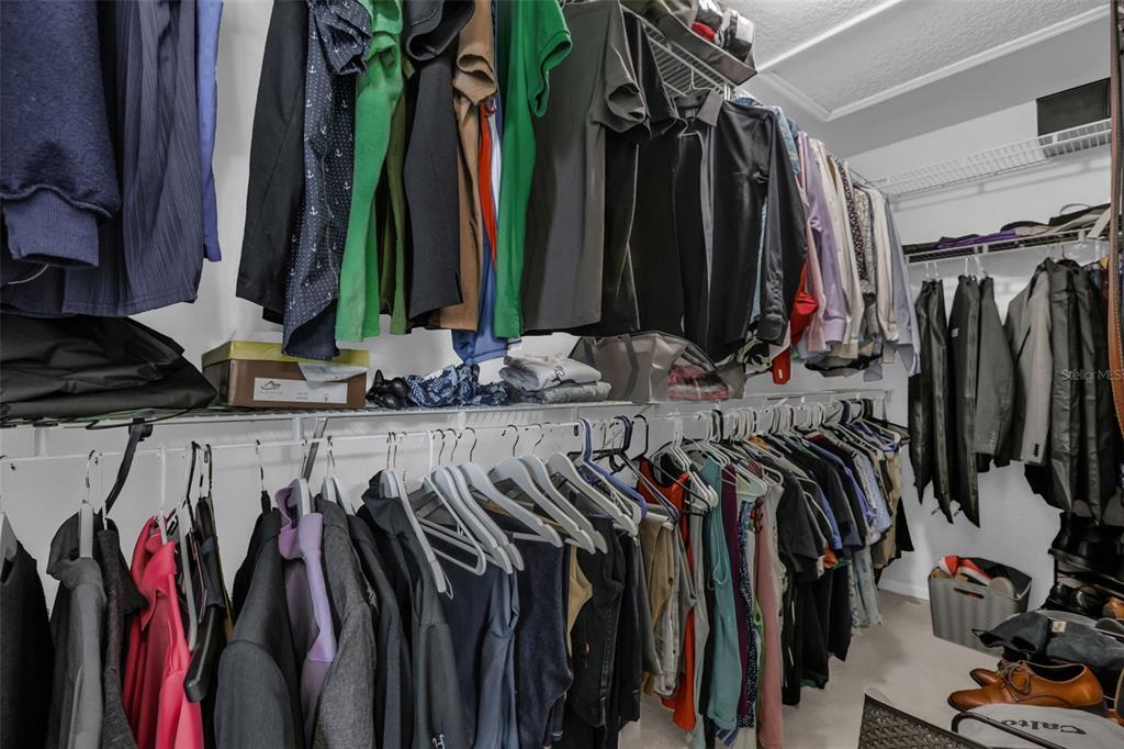 2165 Ridgewood Street Orlando, FL 32803 - Photo 21 of 37 a view of walk in closet with clothes