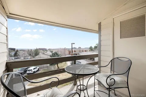 a view of a balcony dining table and chairs