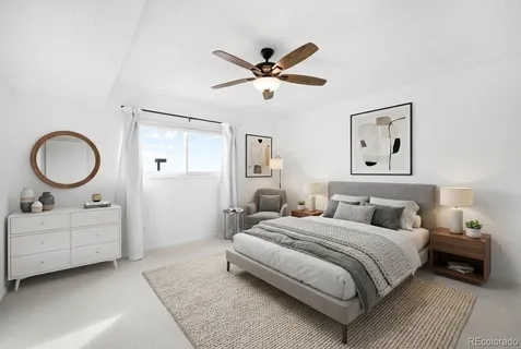 a bedroom with bed and a chandelier