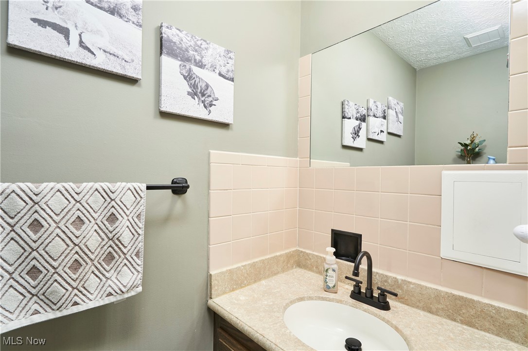 2835 Sunnybrook Road Mogadore, OH 44260 - Photo 15 of 27 Bathroom with vanity and backsplash