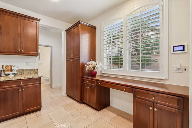 a kitchen with stainless steel appliances granite countertop a sink and dishwasher a refrigerator with wooden cabinets