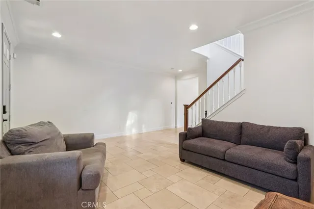 a living room with furniture and stairs