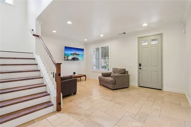 a living room with furniture and stairs