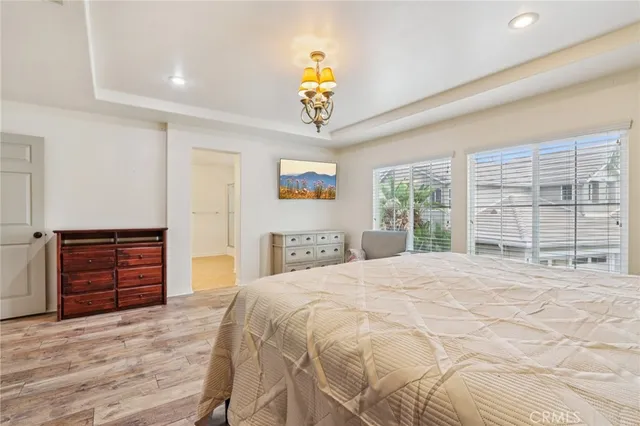 a bedroom with a bed a dresser and a window