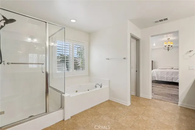 a bathroom with a bathtub and a shower