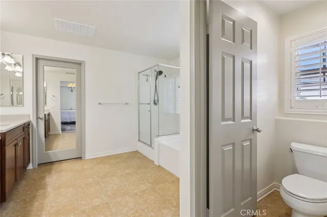 a bathroom with a granite countertop sink mirror vanity and toilet