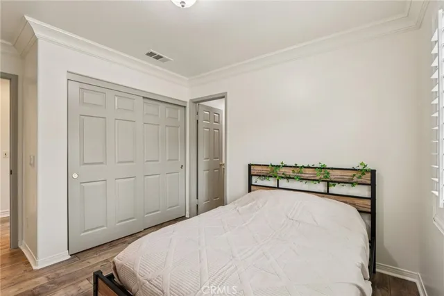 a bedroom with a bed and cabinet