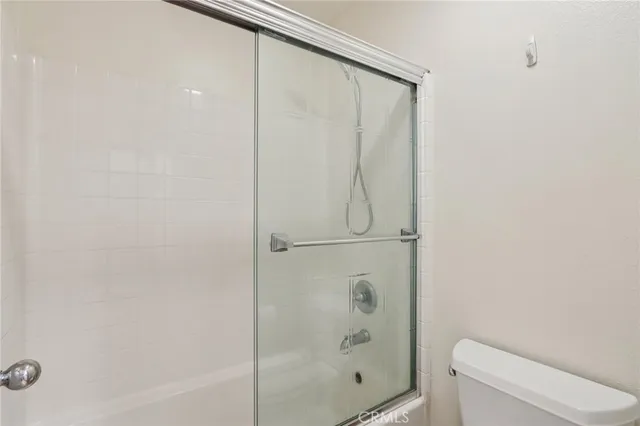 a bathroom with a shower and a toilet
