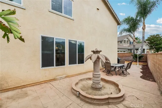 a backyard of a house with table and chairs