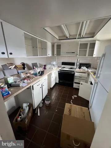a kitchen with storage and utility