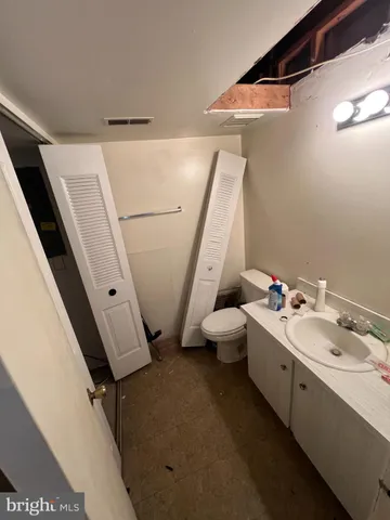 a bathroom with a double vanity sink and mirror with bathtub