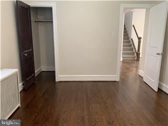 905 Rodman Road Bellefonte, DE 19809 - Photo 11 of 25 a view of a hallway with wooden floor and stairs
