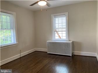 905 Rodman Road Bellefonte, DE 19809 - Photo 14 of 25 an empty room with wooden floor and windows