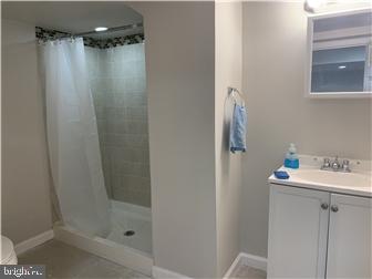 905 Rodman Road Bellefonte, DE 19809 - Photo 23 of 25 a bathroom with a sink mirror and shower