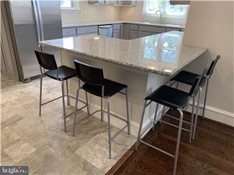 905 Rodman Road Bellefonte, DE 19809 - Photo 5 of 25 a close view of dining table chairs and wooden floor