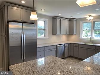 905 Rodman Road Bellefonte, DE 19809 - Photo 6 of 25 a kitchen with a refrigerator and a sink