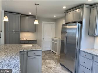 905 Rodman Road Bellefonte, DE 19809 - Photo 9 of 25 a kitchen with stainless steel appliances granite countertop a refrigerator a sink and a stove