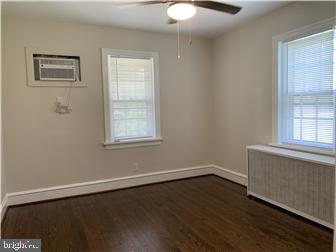 905 Rodman Road Bellefonte, DE 19809 - Photo 10 of 25 a view of an empty room with wooden floor and a window