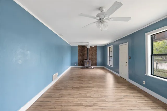 a view of a livingroom with a ceiling fan and window