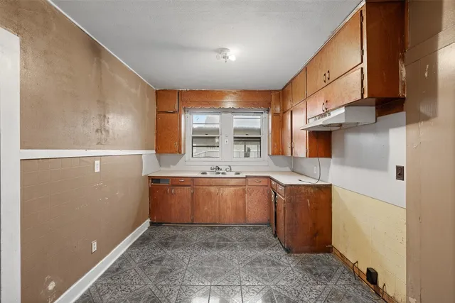 a kitchen with stainless steel appliances granite countertop a refrigerator a stove and a sink