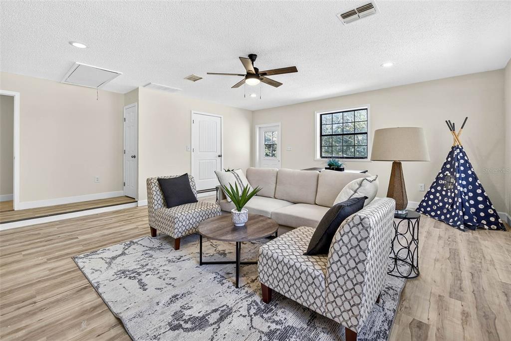 14252 Trinity Road Brooksville, FL 34614 - Photo 10 of 26 a living room with furniture and wooden floor