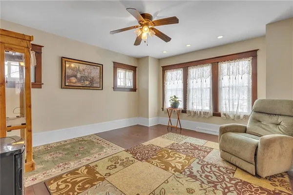 a living room with furniture and a dresser
