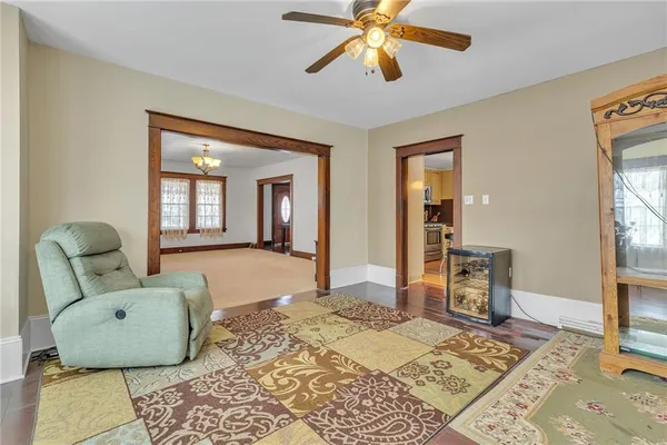 a kitchen with stainless steel appliances granite countertop a refrigerator a sink dishwasher a stove and white cabinets with wooden floor